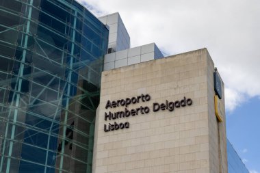 Modern architecture and glass facade of humberto delgado airport - lis - in lisbon, portugal, under a cloudy sky clipart