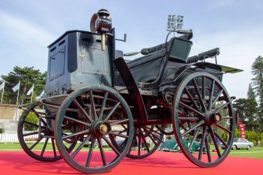 Benz victoria, an early motor carriage, displayed on a red carpet, represents a milestone in automotive history clipart