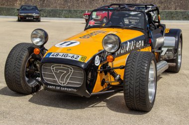 Powerful caterham seven 620r sports car parked on a circuit paddock, ready for a race clipart