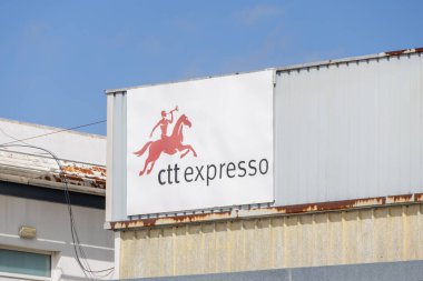 Ctt expresso logo featuring a person riding a horse and blowing a horn, displayed prominently on a building facade against a clear blue sky clipart