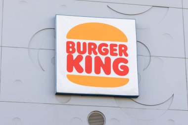 Hamburger Kralı logosu, küresel bir fast food zinciri, modern bir bina cephesinde belirgin bir şekilde sergileniyor.