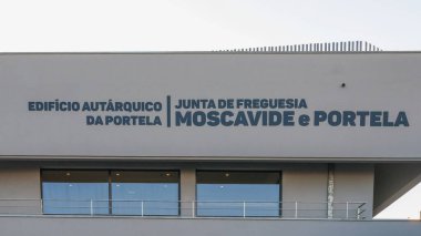 Junta de freguesia moscavide e portela sign on the municipal building in portela, portugal, representing local governance clipart