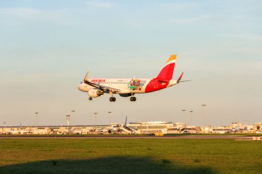 Iberia airbus a320neo landing at lisbon humberto delgado international airport, portugal clipart