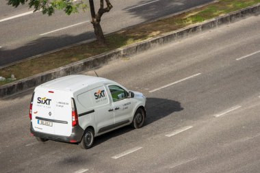 White sixt rental van driving on a multi lane highway clipart