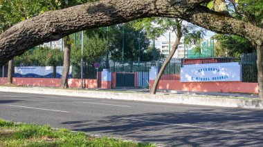 Lizbon, Portekiz 'de güneşli bir günde sokakta görülen özel bir üniversite olan Sao Miguel Arcanjo' nun girişi.