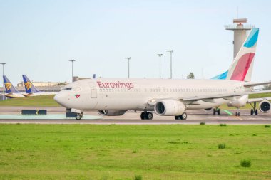 Eurowings aircraft taxiing on the runway of lisbon humberto delgado airport in portugal clipart