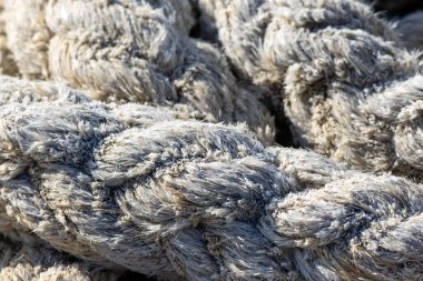 Kalın, sağlam halat, karmaşık örgü ve kenevir liflerinin doğal dokusunu vurguluyor.