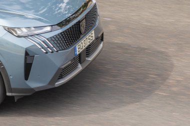 Peugeot 3008 hibrit arabasının önü asfalt yolda hızla ilerliyor.
