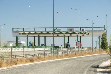 Approaching a toll booth on a multi lane highway in portugal during the day