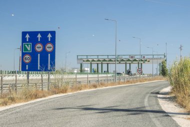 Electronic toll collection lanes on a portuguese highway with a directional sign