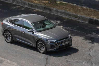 Audi q8 e tron, a gray electric suv, driving on an asphalt road