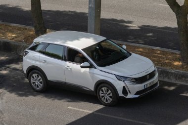 White peugeot 3008 suv transporting a person on a city street