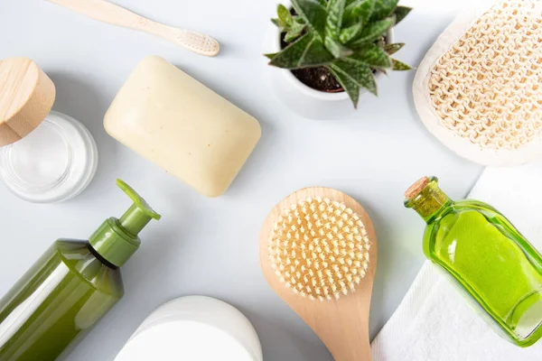 stock image Natural cosmetics, aloe flower and bath accessories of personal hygiene and eco-materials are on a gray background. View from the top point.