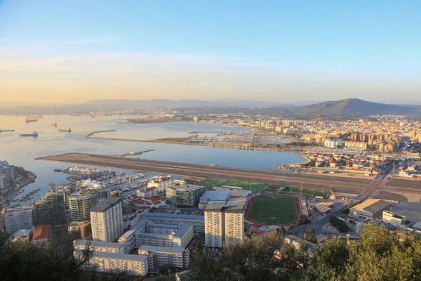 Beautiful cityscape of strait in Gibraltar. View of the evening city of Gibraltar with a view of the runway and football from the top point. United Kingdom.