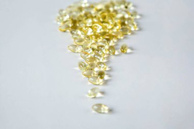 D vitamini içeren şeffaf kapsüller gri bir zemin üzerindedir. Boşluğu kopyala... yukarıdan görüntüle.