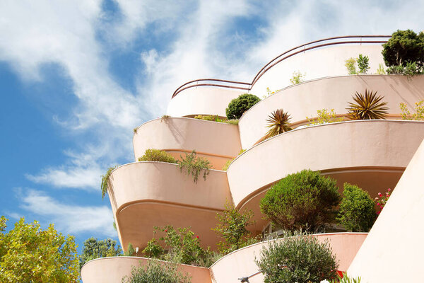View of residential buildings with flowering rounded  terraces against a blue sky. European architecture. Portugal.