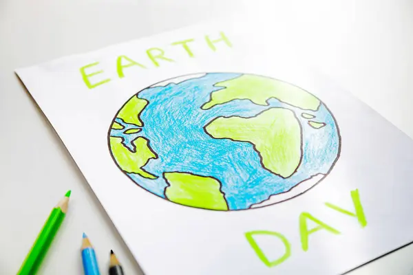 A drawing of the green planet painted with colored pencils. Earth Day.
