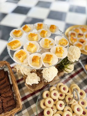 An assortment of desserts, sweets, and pastries adorns the holiday buffet table. Vertical image. clipart