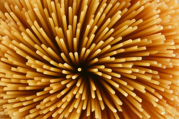 Italian spaghetti pasta. Flower of spaghetti gathered in a bunch. View from the top