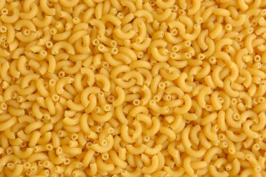 Top view of Italian uncooked pipe pasta. Food texture. clipart