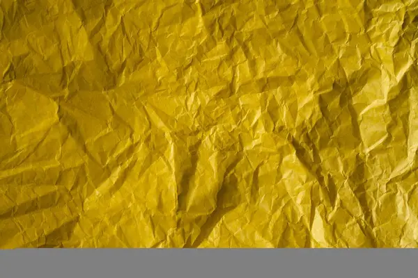 Yellow crinkled wrapping paper with a lot of texture. Concept backgrounds and templates.