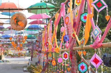 An ancient merit-making tradition using artifacts and decorative flags according to the religious beliefs of communities in the Northeast of Thailand.