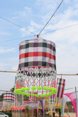 An ancient merit-making tradition using artifacts and decorative flags according to the religious beliefs of communities in the Northeast of Thailand.