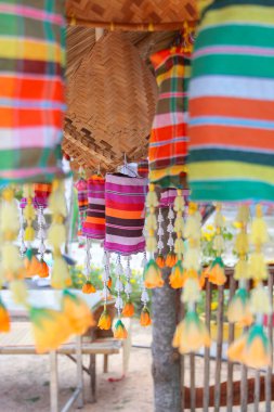 An ancient merit-making tradition using artifacts and decorative flags according to the religious beliefs of communities in the Northeast of Thailand.