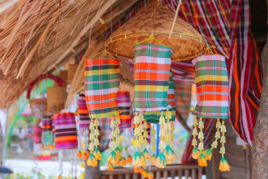An ancient merit-making tradition using artifacts and decorative flags according to the religious beliefs of communities in the Northeast of Thailand.