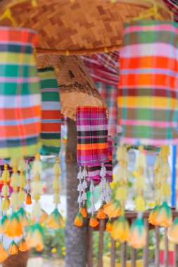 An ancient merit-making tradition using artifacts and decorative flags according to the religious beliefs of communities in the Northeast of Thailand.