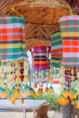 An ancient merit-making tradition using artifacts and decorative flags according to the religious beliefs of communities in the Northeast of Thailand.