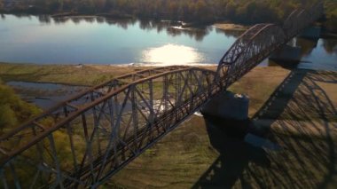 Old railway bridge over a river. Drone flight over bridge of old narrow gauge railway