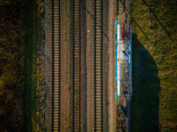 从空中俯瞰货运列车 这是一条在农村的双轨铁路 铁路上长满了青草 树荫漫漫 尽收眼底 运输基础设施 夏季性质 — 图库照片