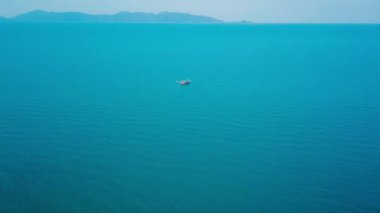 Aerial view drone tracking a tourist thai longtail fishing boat in phuket islands,Amazing andaman sea in Phuket Thailand on a sunny morning with beautiful sea background