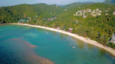 4k Drone Footage of the Beach at Mae Nam on Koh Samui in Thailand, Including Beachfront Resorts with Beautiful Clouds in the Sky and Crystal Teal Water