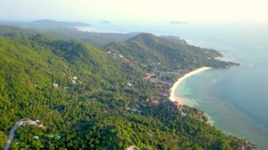4k Aerial Drone Push Forward Shot of Salad Beach on Koh Phangan in Thailand with Fishing Boats, Teal Water, Coral, and Green Jungles