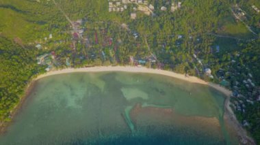 4k Aerial Drone Push Forward Shot of Salad Beach on Koh Phangan in Thailand with Fishing Boats, Teal Water, Coral, and Green Jungles