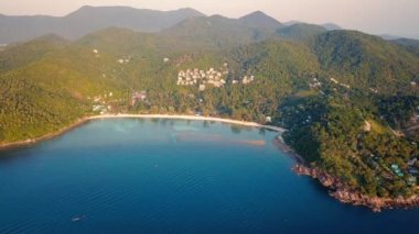 4k Aerial Drone Push Forward Shot of Salad Beach on Koh Phangan in Thailand with Fishing Boats, Teal Water, Coral, and Green Jungles