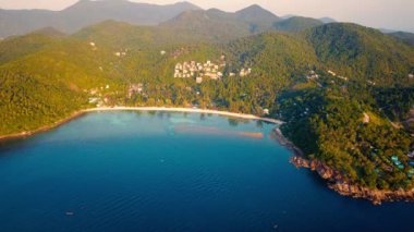 4k Aerial Drone Push Forward Shot of Salad Beach on Koh Phangan in Thailand with Fishing Boats, Teal Water, Coral, and Green Jungles