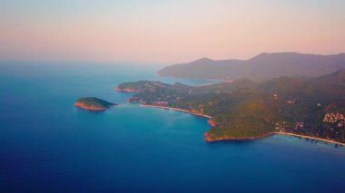 4k Aerial Drone Push Forward Shot of Salad Beach on Koh Phangan in Thailand with Fishing Boats, Teal Water, Coral, and Green Jungles