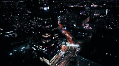 Aerial view of office windows in a modern skyscraper in the city center at night. Close-up of windows of offices in a skyscraper, business center