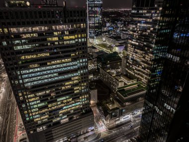 Office building still operate at very late night with many office worker doing part time work. Salary man overworking issue concept in urban of countries and urban night skyline.