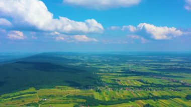 Beautiful Aerial View of Green Agricultural field on Sunrise. Drone flying over harvest crops Amazing Sunrise TimeLapse of the Green Wheat field and beautiful cloudscape with rising sun.