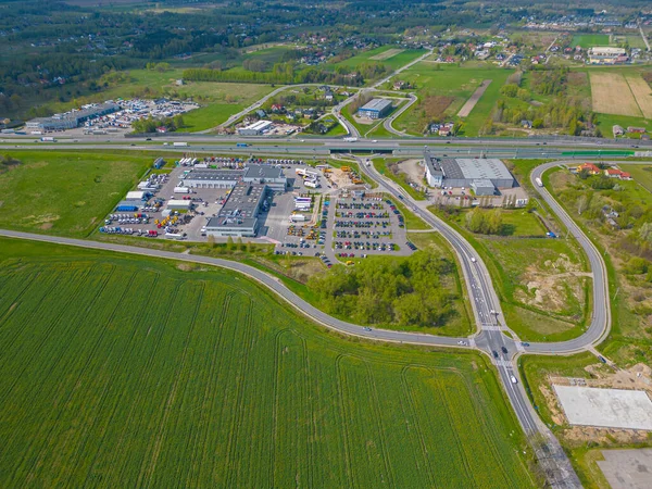 Logistics park with warehouse. Semi-trailers trucks standing on car parking and waiting for loading and unloading goods at ramps. Aerial view