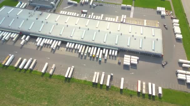商品倉庫の空中ビュー 上記から工業都市ゾーンの物流センター 物流センターにおける荷役トラックの空中図 — ストック動画