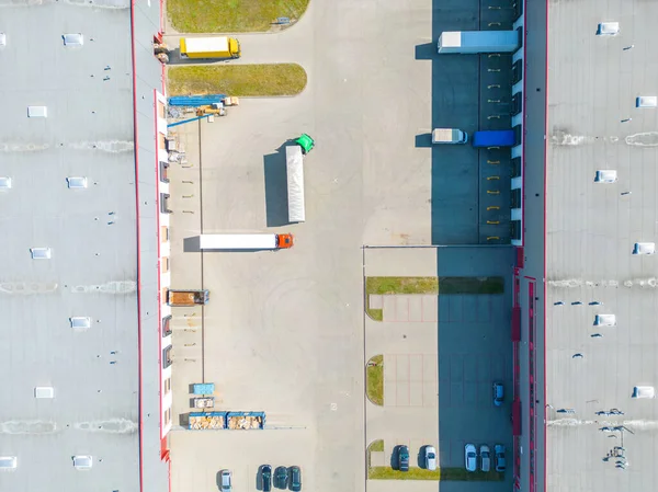 stock image Aerial view of distribution center, drone photo of industrial logistics zone,new super modern logistics center full of modern technology and robotics,roof solar power plant for green energy production