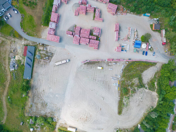 Aerial view of warehouse storages or industrial factory or logistics center from above. Aerial view of industrial buildings and equipment at sunset, toned