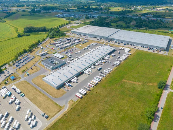 stock image Aerial view of warehouse storages or industrial factory or logistics center from above. Aerial view of industrial buildings and equipment at sunset, toned