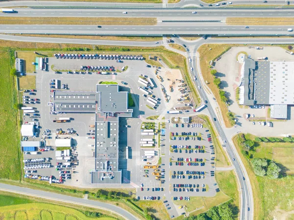 stock image Aerial view of goods warehouse. Logistics center in industrial city zone from above. Aerial view of trucks loading at logistic center