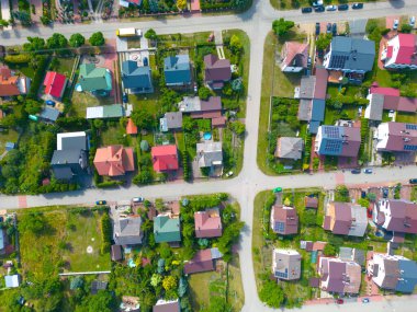 Aerial view of residential houses at spring.  neighborhood, suburb. Real estate, drone shots, sunset, sunlight, from above. clipart